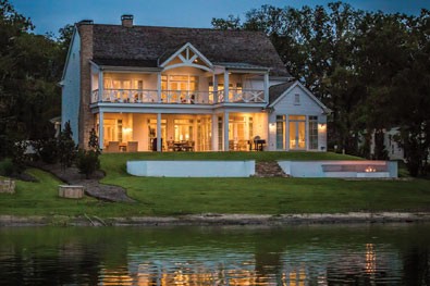 custom waterfront lake home at dusk long cove