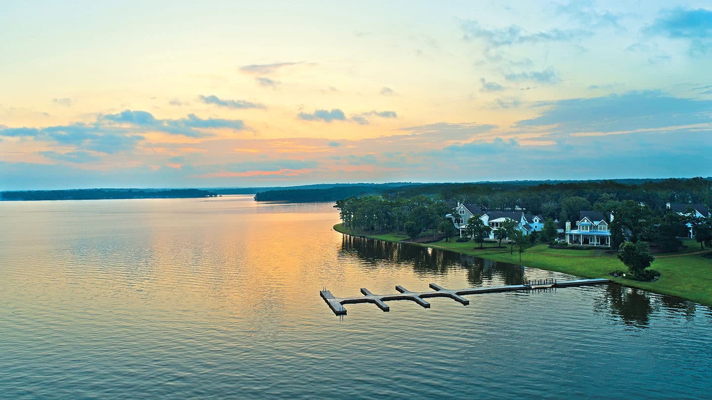 Arial view of shoreline homes and dock sunset Long Cove at Cedar Creek Lake