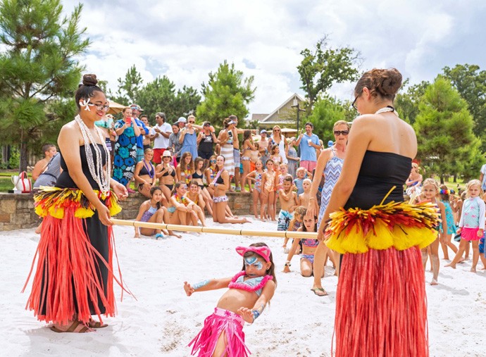 Child playing limbo at a luau event