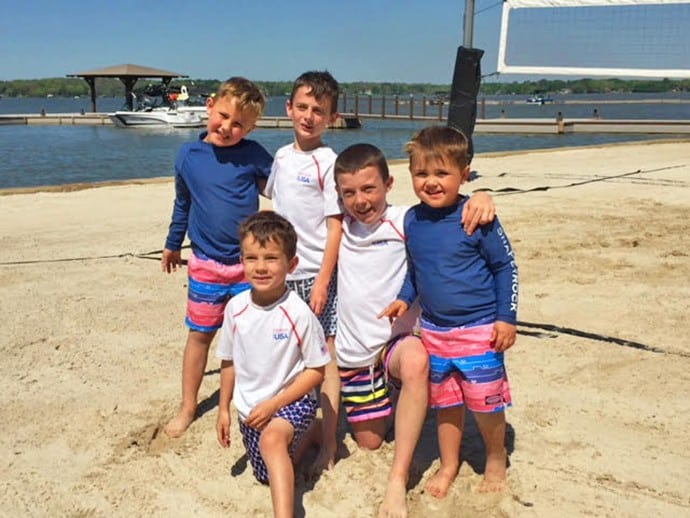 group of kids posing for a picture on the shores of long cove