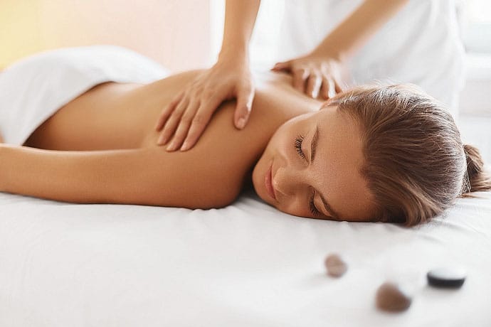 Woman getting a massage highlighting Long Cove Concierge Services