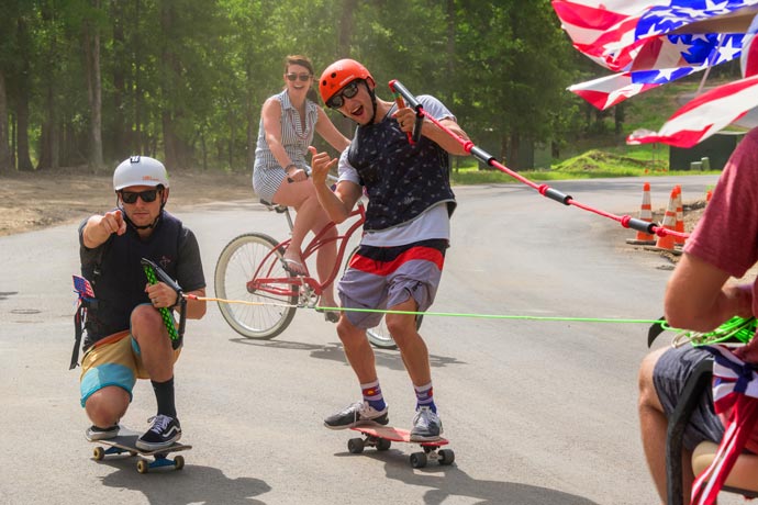 residents posing on skate boards at july 4th party at Long Cove