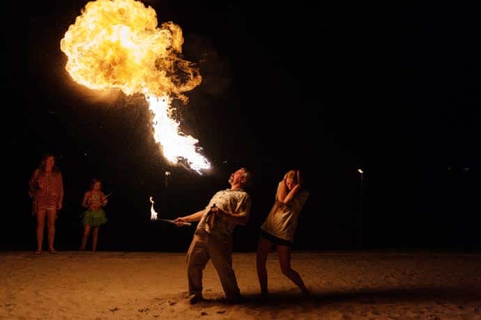 entertainers blowing fire for crowd at Long Cove labor day luau resident event