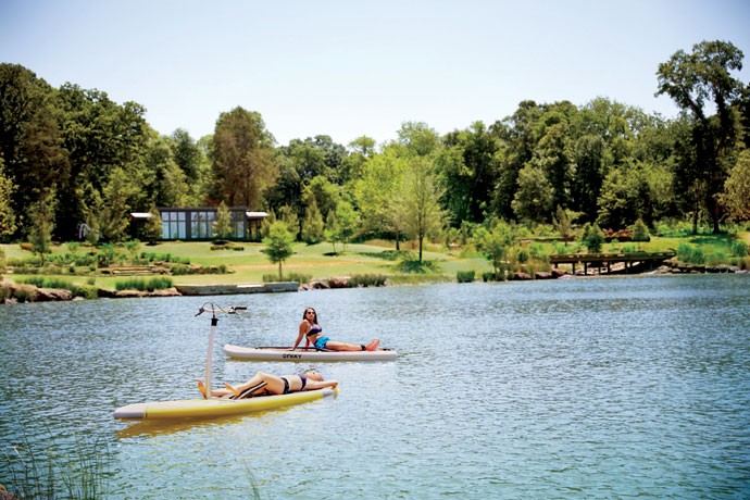 2 women on paddle boards relaxing on cedar creek lake