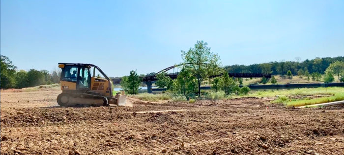 Tractor moving dirt illustrating the update on Henderson Bay