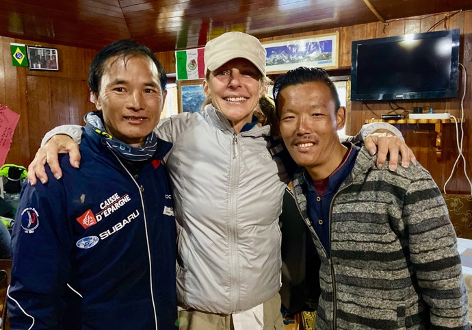 Karen Northcutt smiling with her guides at Everest Base Camp