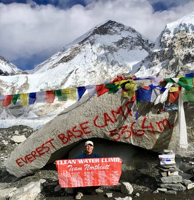 Woman displaying a sign at Everest Base Camp