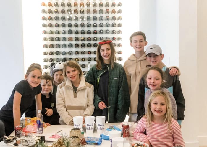 Group of children wrapping up lunch and smiling at camera