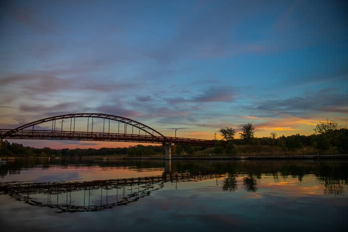 A sunset view of the Long Cove Bridge over the water of Cedar Creek Lake.
